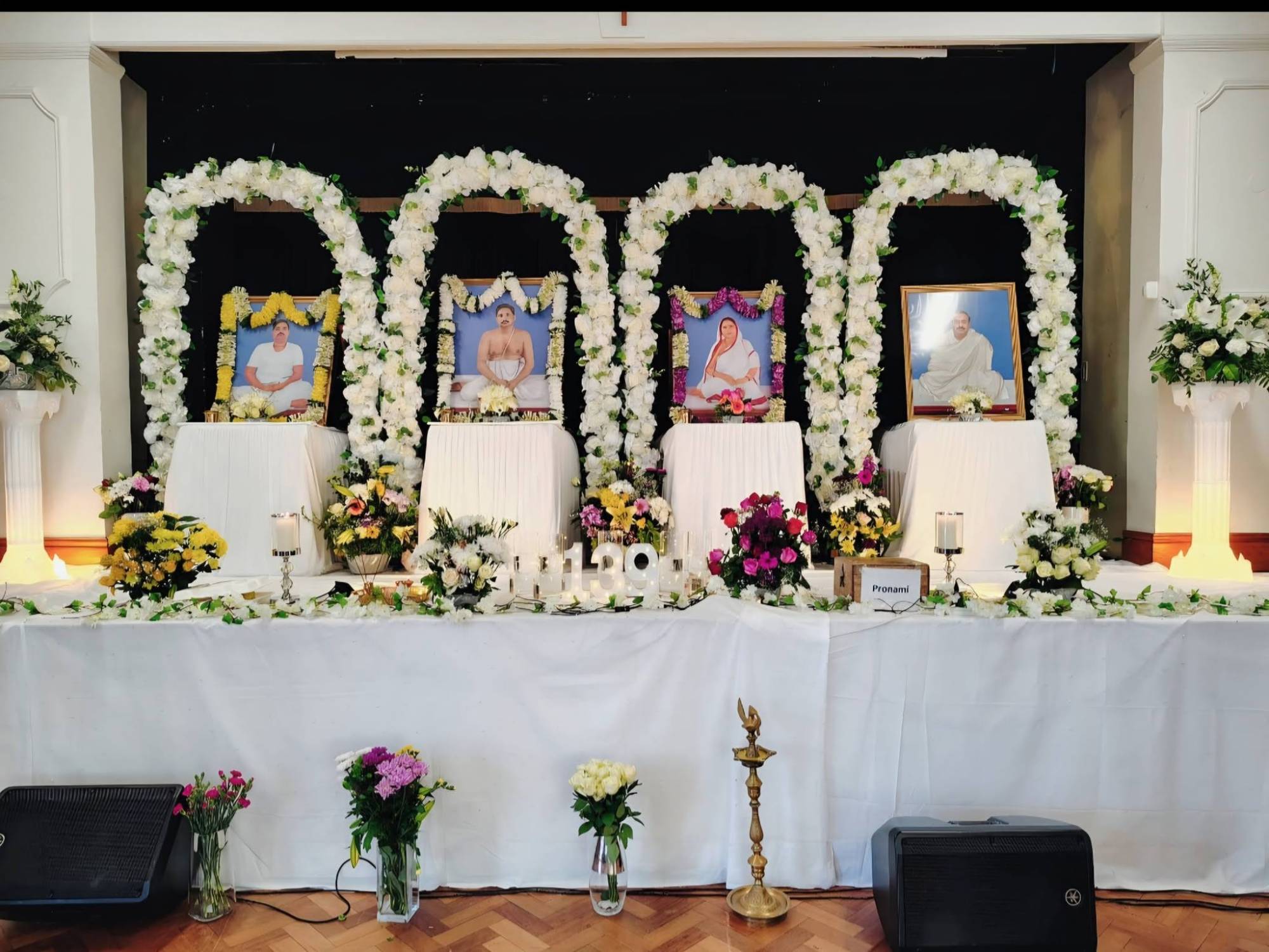 Altar with garlands and the Thakur's photographs